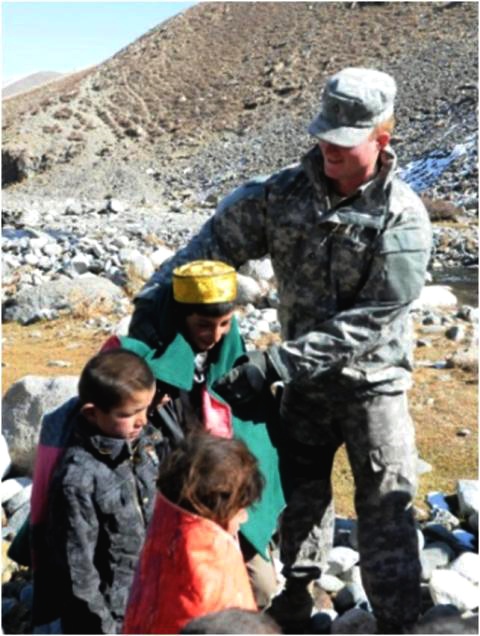 U.S. Soldier Provides Warm Blanket to Afghan Resident