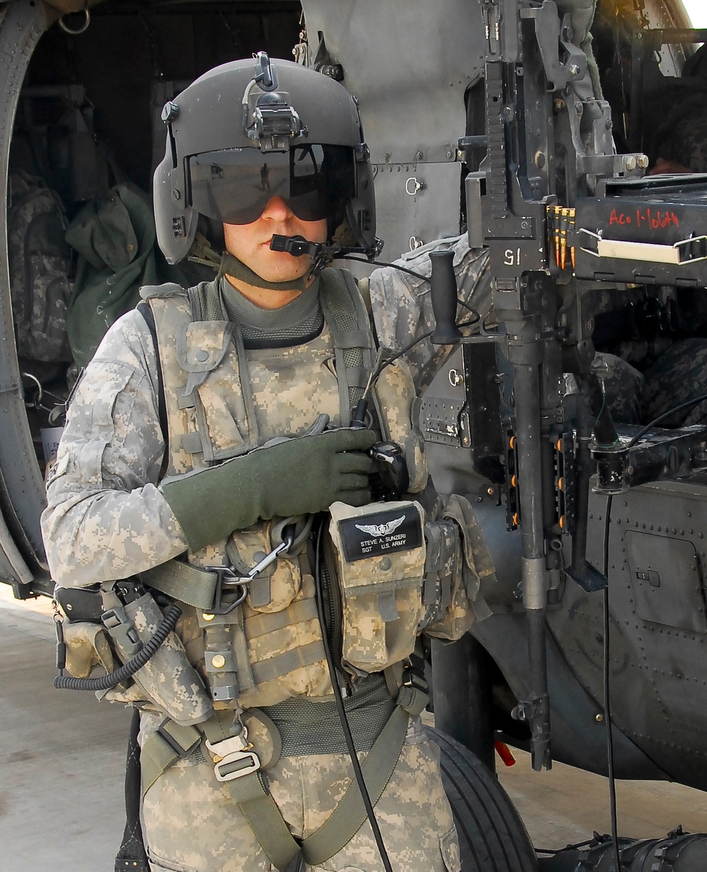 Army Sgt. Sunzeri Stands by Black Hawk Helicopter in Iraq