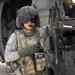 Army Sgt. Sunzeri Stands by Black Hawk Helicopter in Iraq