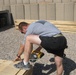 Soldier Constructs Shelves for Tent at Iraqi Base