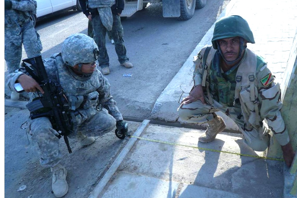 U.S. Soldier Collaborates with Iraqi Counterpart to Assess Bridge Condition
