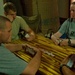 Soldiers and Interpreter Enjoy Downtime with Dominoes Game in Iraq