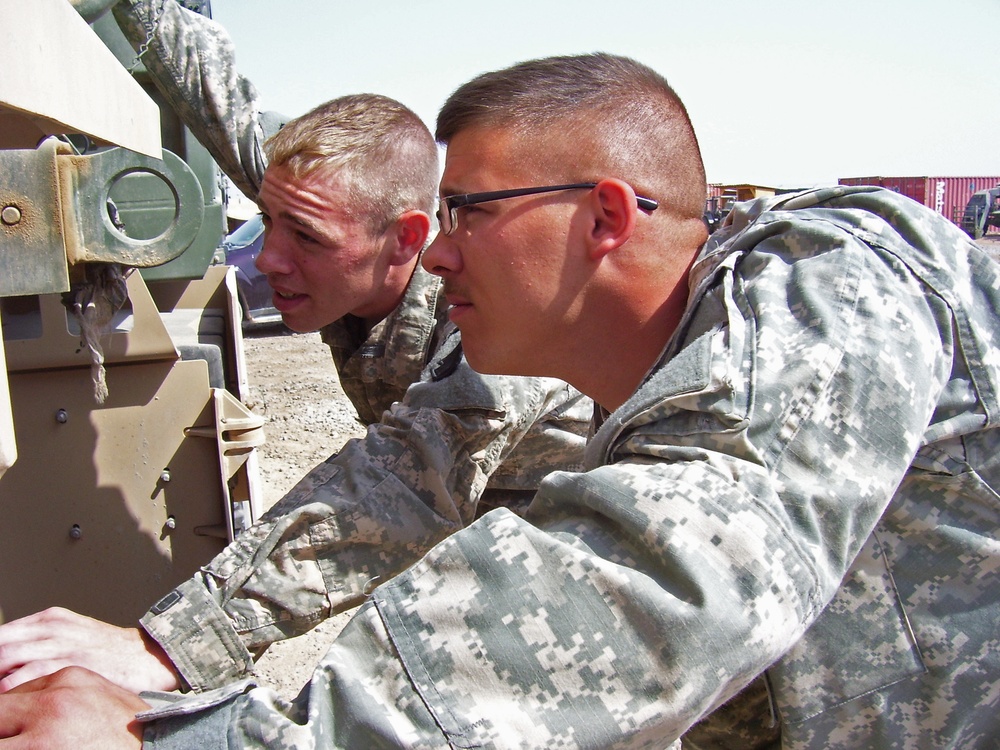 Army Soldiers Inspect Truck at Iraqi Base