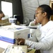 Air Force Postal Worker Sorts Mail for Troops Overseas Ahead of Holidays
