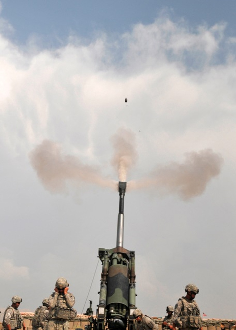 Soldiers firing an M198 howitzer at Forward Operating Base Mehtar Lam in Afghanistan