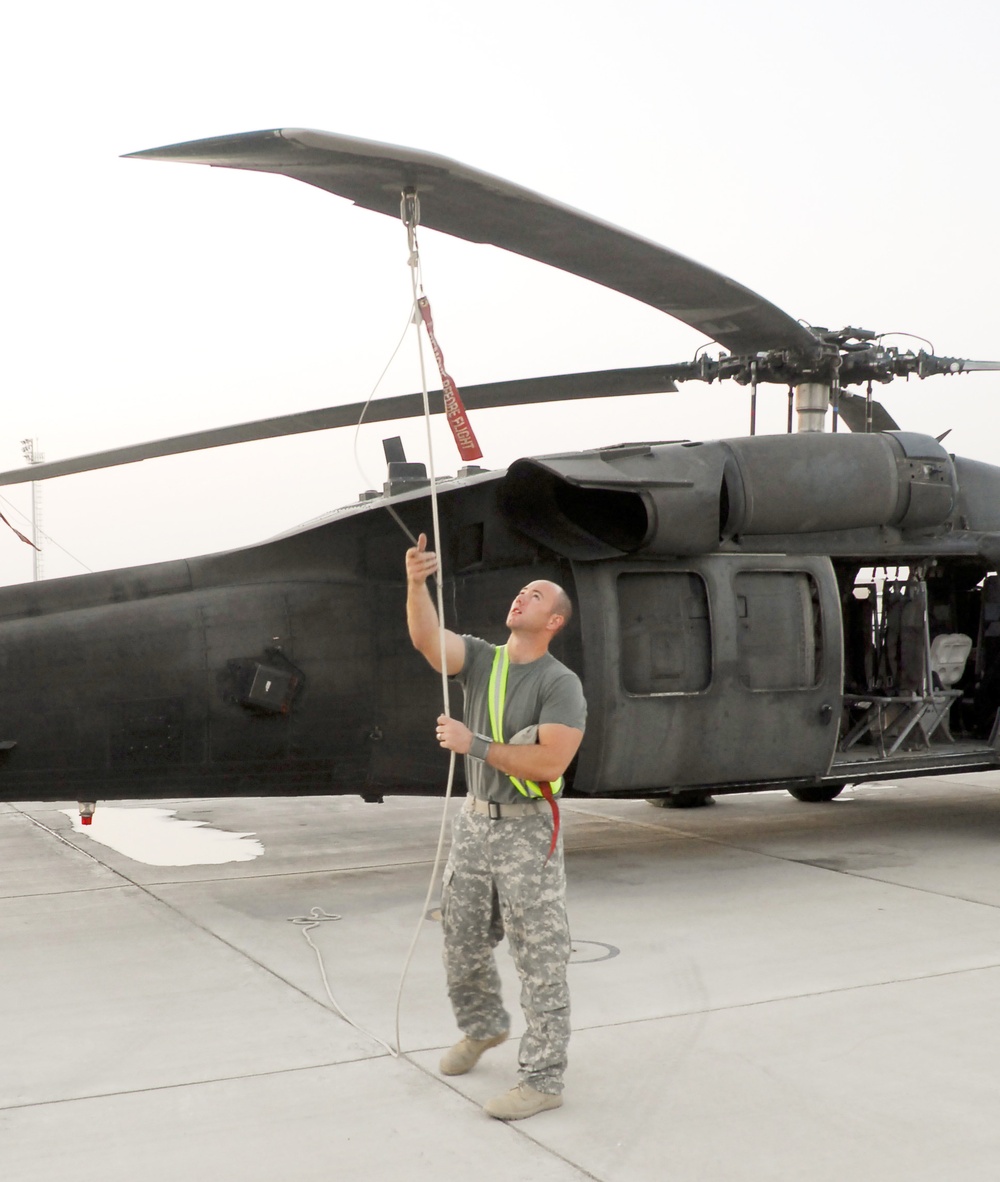 Army Staff Sgt. Prepares Black Hawk for Early Morning Flight