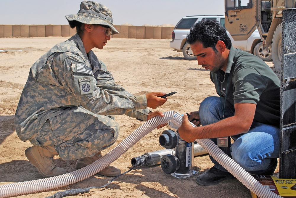 U.S. Soldier and Iraqi Engineer Demonstrate Solar-Powered Water Filtration System