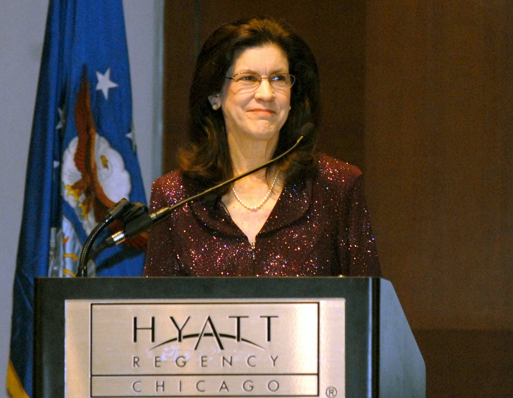 Army General's Wife Smiles at Husband's Remarks at Defense Department Conference