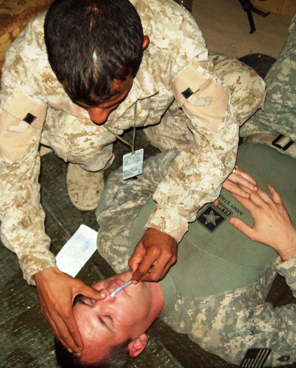 Iraqi Trainee Practices Lifesaving Technique on U.S. Soldier