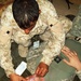 Iraqi Trainee Practices Lifesaving Technique on U.S. Soldier