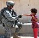 Army Soldier Greets Iraqi Girl at Checkpoint