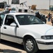 Iraqi Federal Police Conduct Vehicle Search at Checkpoint Near Baghdad