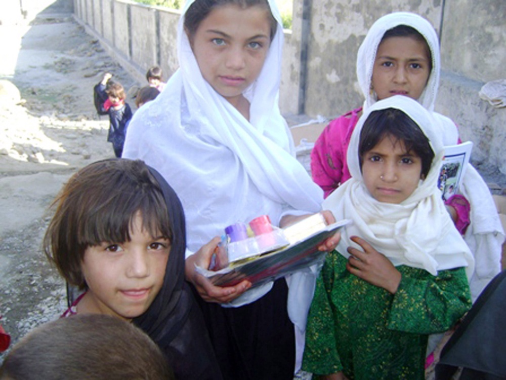 Afghan Girls Proudly Display New School Supplies