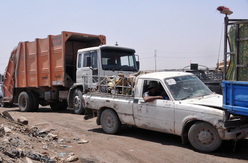 Civilian Laborers Haul Trash to Basra Dump in Iraq
