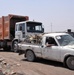 Civilian Laborers Haul Trash to Basra Dump in Iraq