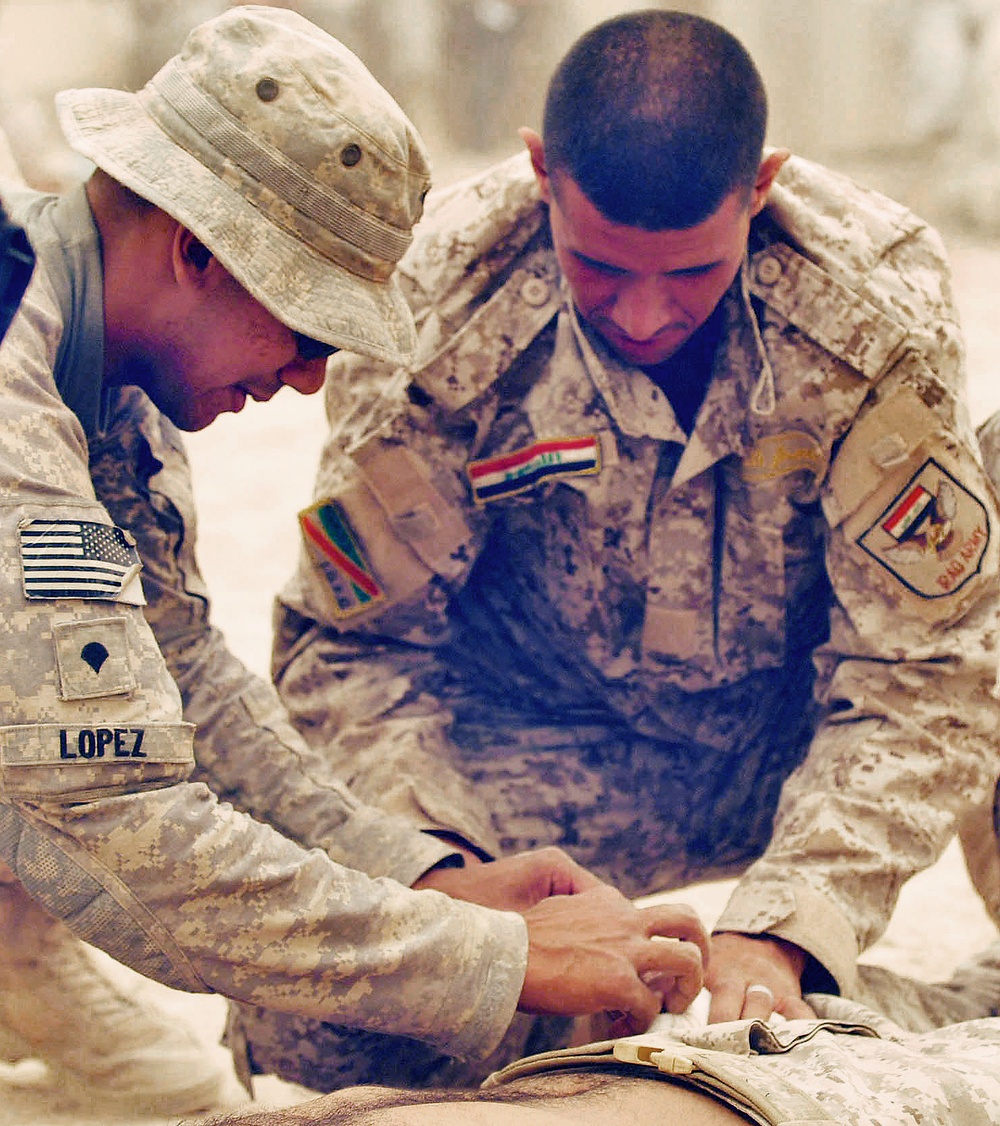 U.S. Soldier Trains Iraqi Counterpart on Battlefield First Aid