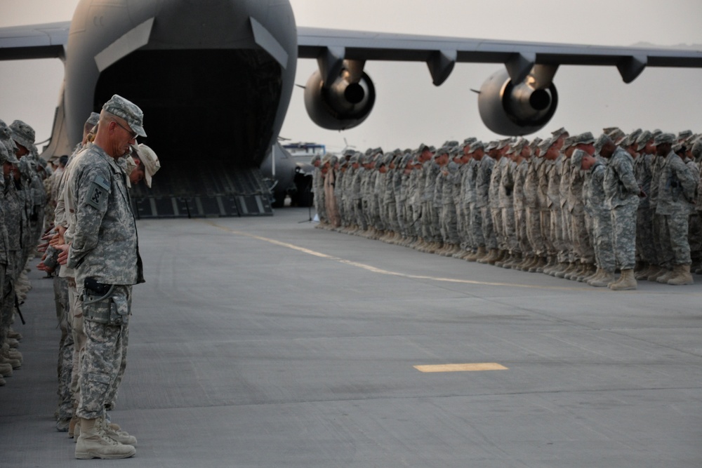 Solemn Farewell: Troops Honor Fallen Comrade at Ramp Ceremony in Afghanistan
