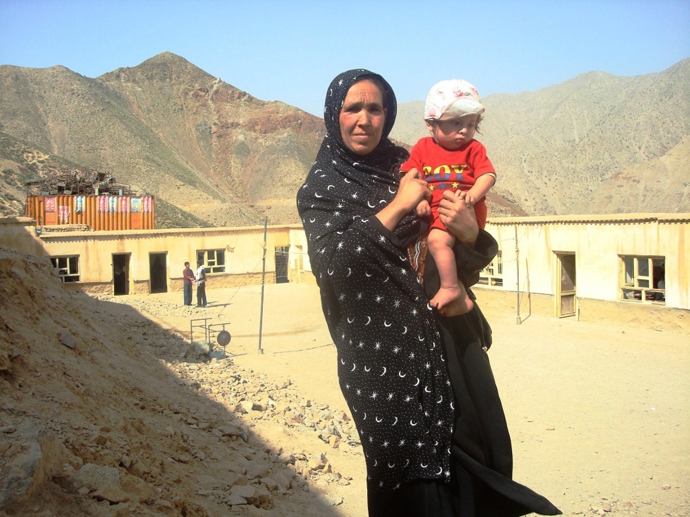 Nafisa, Principal of Shutol Primary School, Holds Baby as New School is Built in Afghanistan