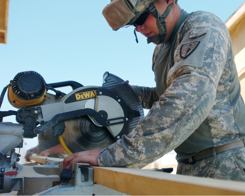 Soldier Builds Covering for New Water Pump at Afghan Outpost