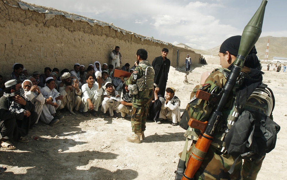 Afghan Army Leader Meets with Village Elders During Aid Mission
