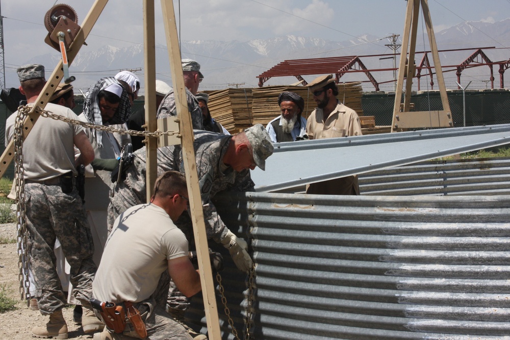 U.S. Troops Assist Afghan Farmers in Assembling Grain Storage Bins
