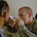 Army Captain Examines Patient's Eye at Medical Engagement in Iraq