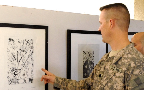 Army Officer Inspects Student Art at Baghdad School