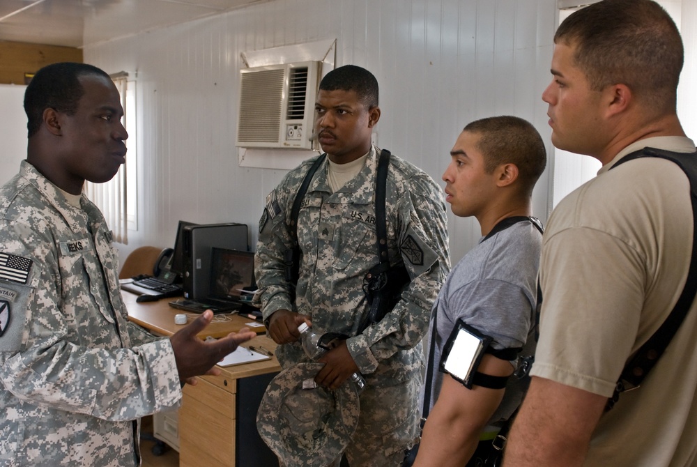 Army Chief Warrant Officer Discusses Education Programs with Soldiers in Iraq