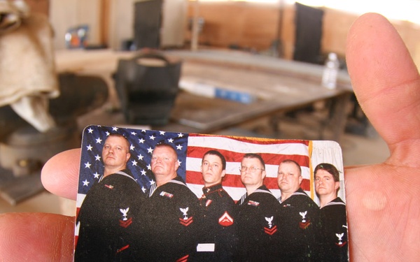 Navy Petty Officer Holds Photo of Family Members Serving in Military
