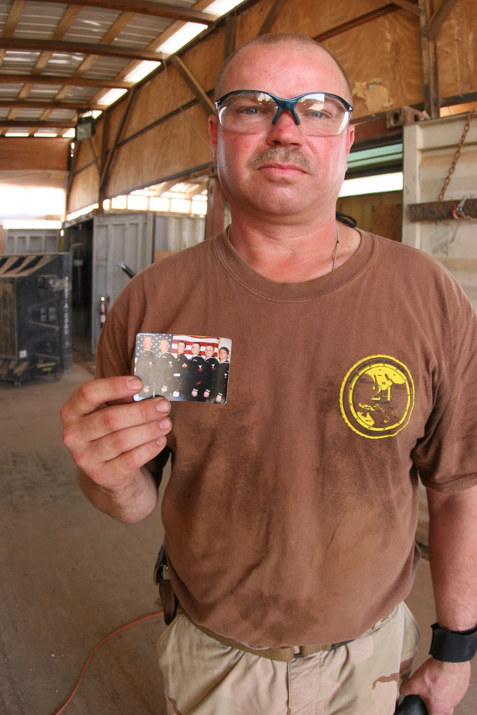 Navy Petty Officer Holds Photo of Family's Military Service