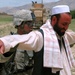 U.S. Soldier Conducts Security Check at Afghan Traffic Checkpoint