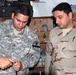U.S. Soldier Trains Iraqi Counterpart in Fiber Optic Repair