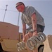 Soldier Lifts Humvee Springs in Fitness Training at Iraqi Base