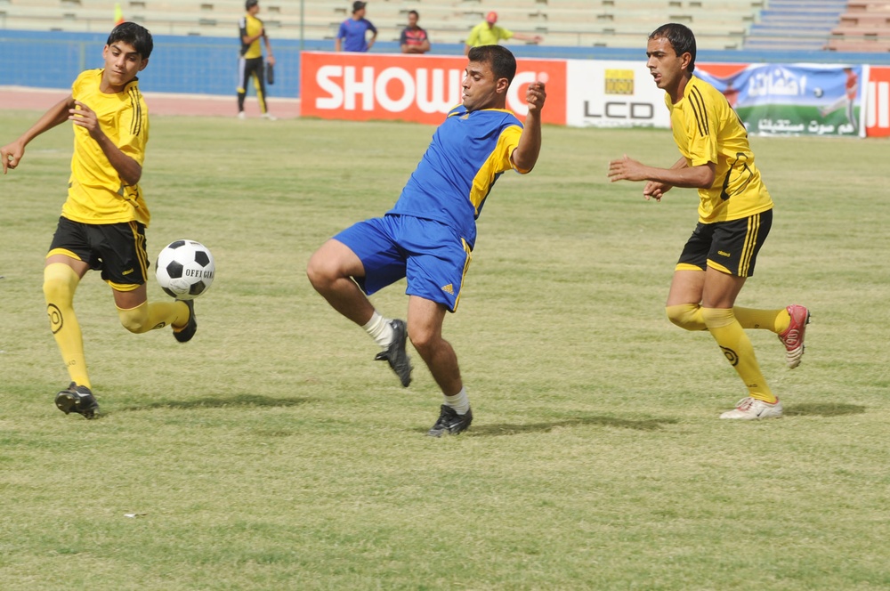 Iraqi Soccer Team Battles for Possession at Shaab Stadium