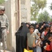 Iraqi Women Receive Food Aid from National Police in Taji