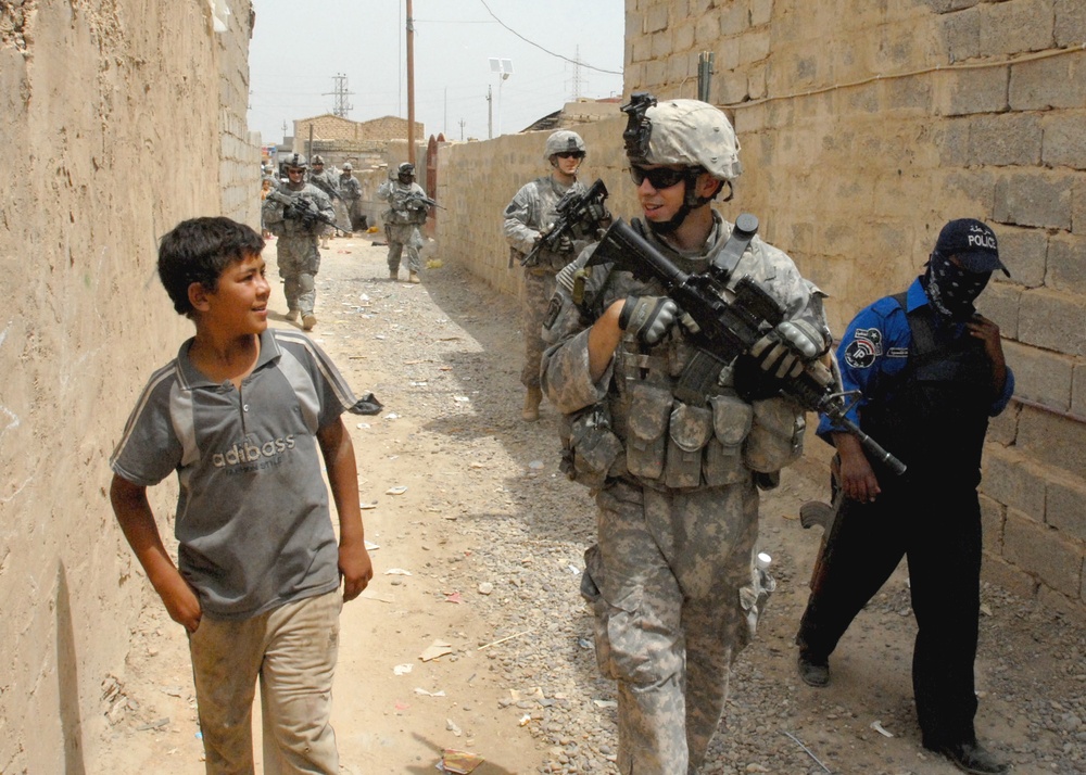 U.S. Soldier Engages with Iraqi Youth in Taji Market
