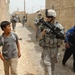 U.S. Soldier Engages with Iraqi Youth in Taji Market