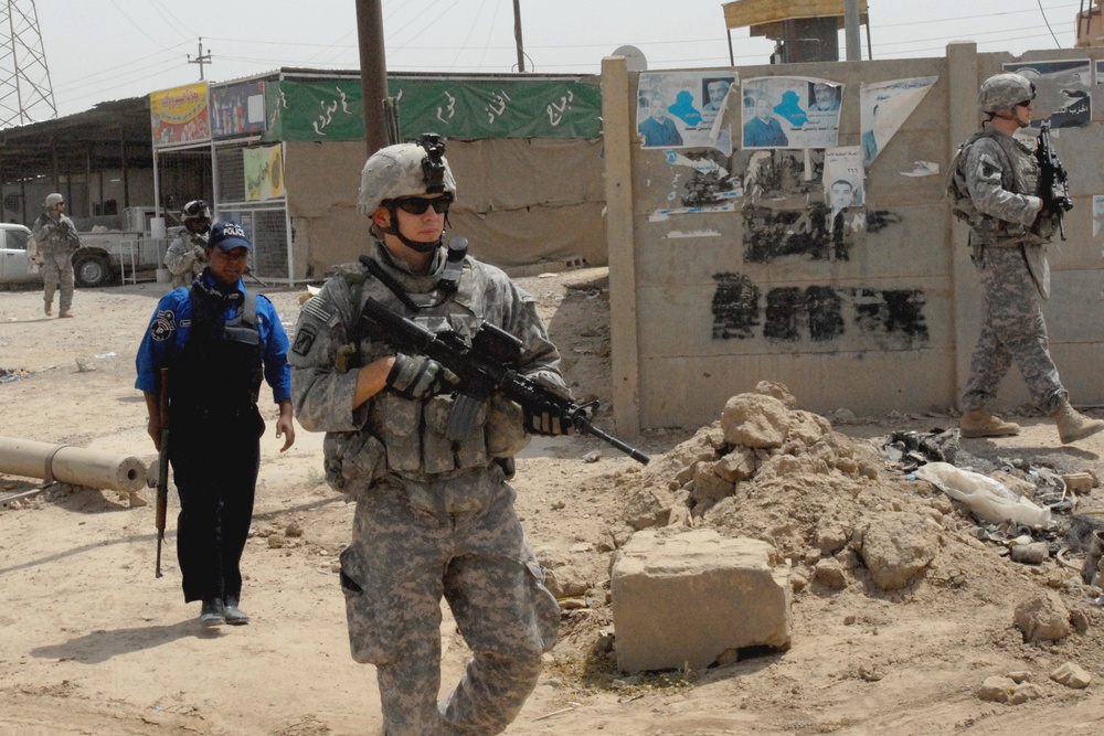 U.S. Soldier Patrols Taji Market with Iraqi Police