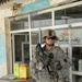 U.S. Soldier Provides Security During Patrol in Iraqi Marketplace