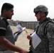 U.S. Soldier and Iraqi Contractor Discuss Wall Construction Project in Baghdad