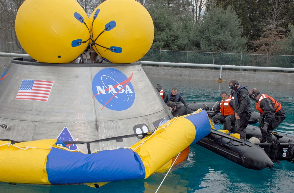 Pararescuemen Deploy Floatation Collar Around Orion Crew Module During Testing