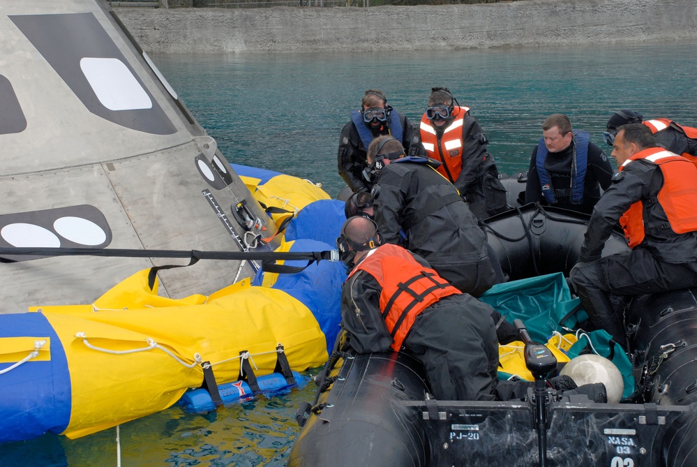 Pararescuemen Deploy Floatation Collar Around Orion Crew Module During Testing