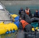 Pararescuemen Deploy Floatation Collar Around Orion Crew Module During Testing