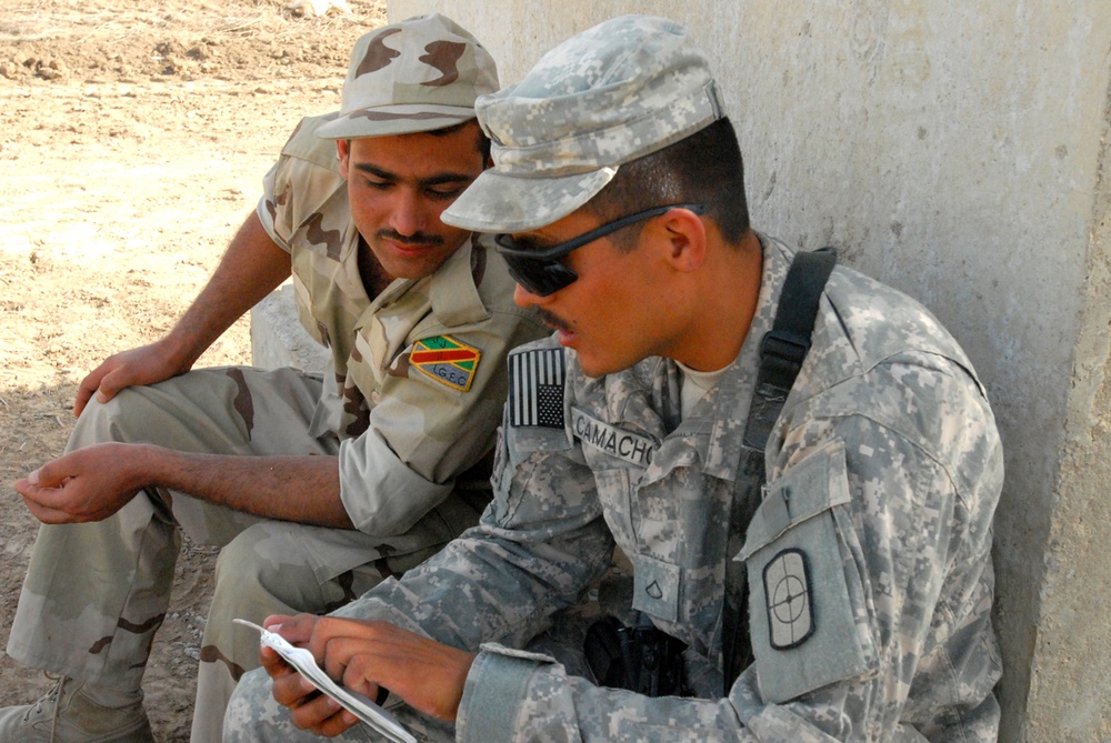 U.S. Soldier Practices Arabic with Iraqi Counterpart