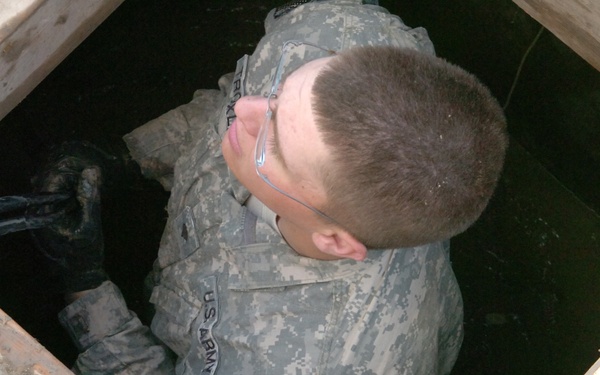 Soldier Maintains Communications in Flooded Afghan Base