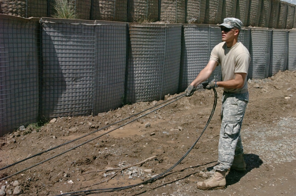 Army Spc. Sudbeck Lays Fiber-Optic Cable at Afghan Base