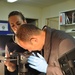 Forensic Examiner Collects Fingerprints from CD in Iraq