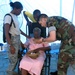 Military Members Provide Eyeglasses to Elderly Woman During Humanitarian Mission