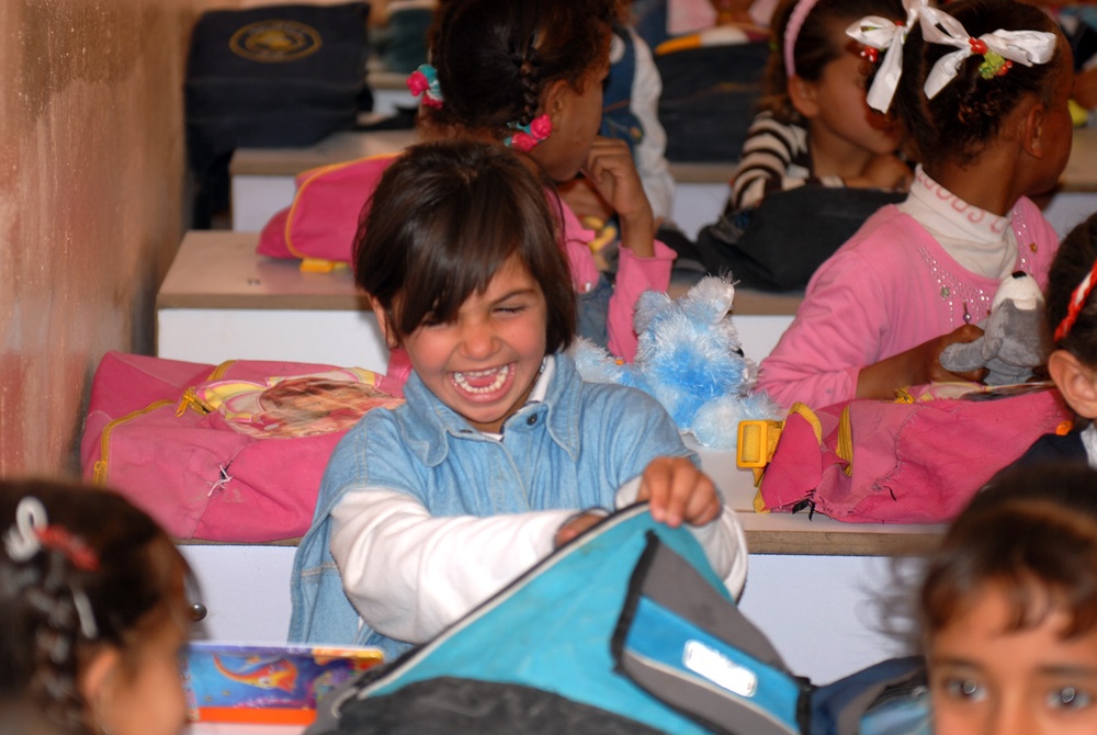 Iraqi Girl Receives Backpack of School Supplies from Coalition Forces