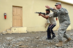 U.S. Soldier Trains Afghan Police in Weapons Tactics